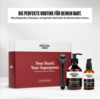 Brooklyn Soap Company beard care set with box, beard roller, shampoo, and serum – labeled “Your Beard. Your Superpower.”